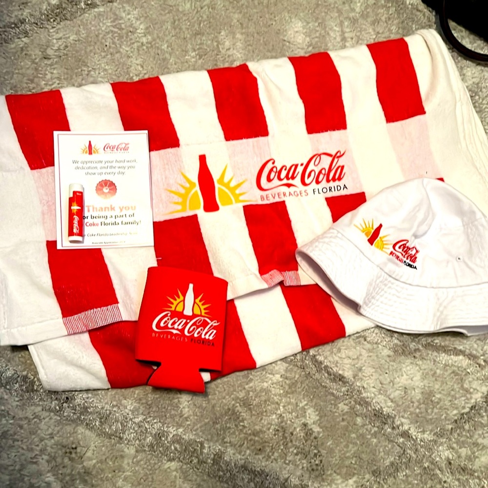 Coca Cola pack towel, bucket hat, chapstick, beer coozy .